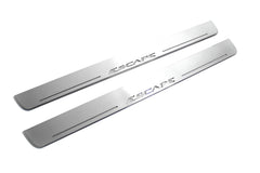 Two long silver-finished door sill plates with Escape lettering on a light background, angled view.
