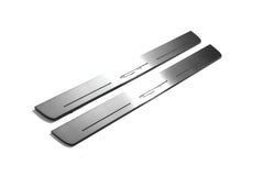 Two long silver-finished door sill plates with GT lettering on a light background, angled view.