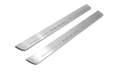 Two long silver-finished door sill plates with Model 3 lettering on a light background, angled view.