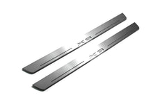 Two long silver-finished door sill plates with X6 lettering on a light background, angled view.