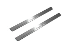 Two long silver-finished door sill plates with Accent lettering on a light background, angled view.
