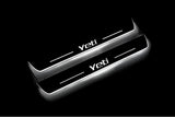 Two long door sill plates with Yeti lettering and edges illuminated in white, angled view on a dark background.