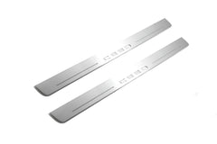 Two long silver-finished door sill plates with Ceed lettering on a light background, angled view.