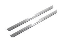 Two long silver-finished door sill plates with Vivaro lettering on a light background, angled view.