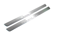 Two long silver-finished door sill plates with Range Rover lettering on a light background, angled view.