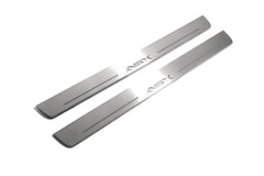 Two long silver-finished door sill plates with ASX lettering on a light background, angled view.