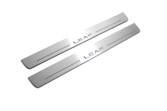 Two long silver-finished door sill plates with Leaf lettering on a light background, angled view.