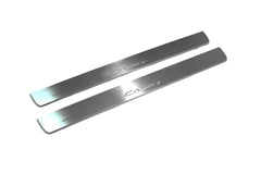 Two long silver-finished door sill plates with Camry lettering on a light background, angled view.