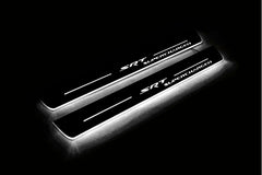 Two long door sill plates with SRT Supercharged lettering and edges illuminated in white, angled view on a dark background.