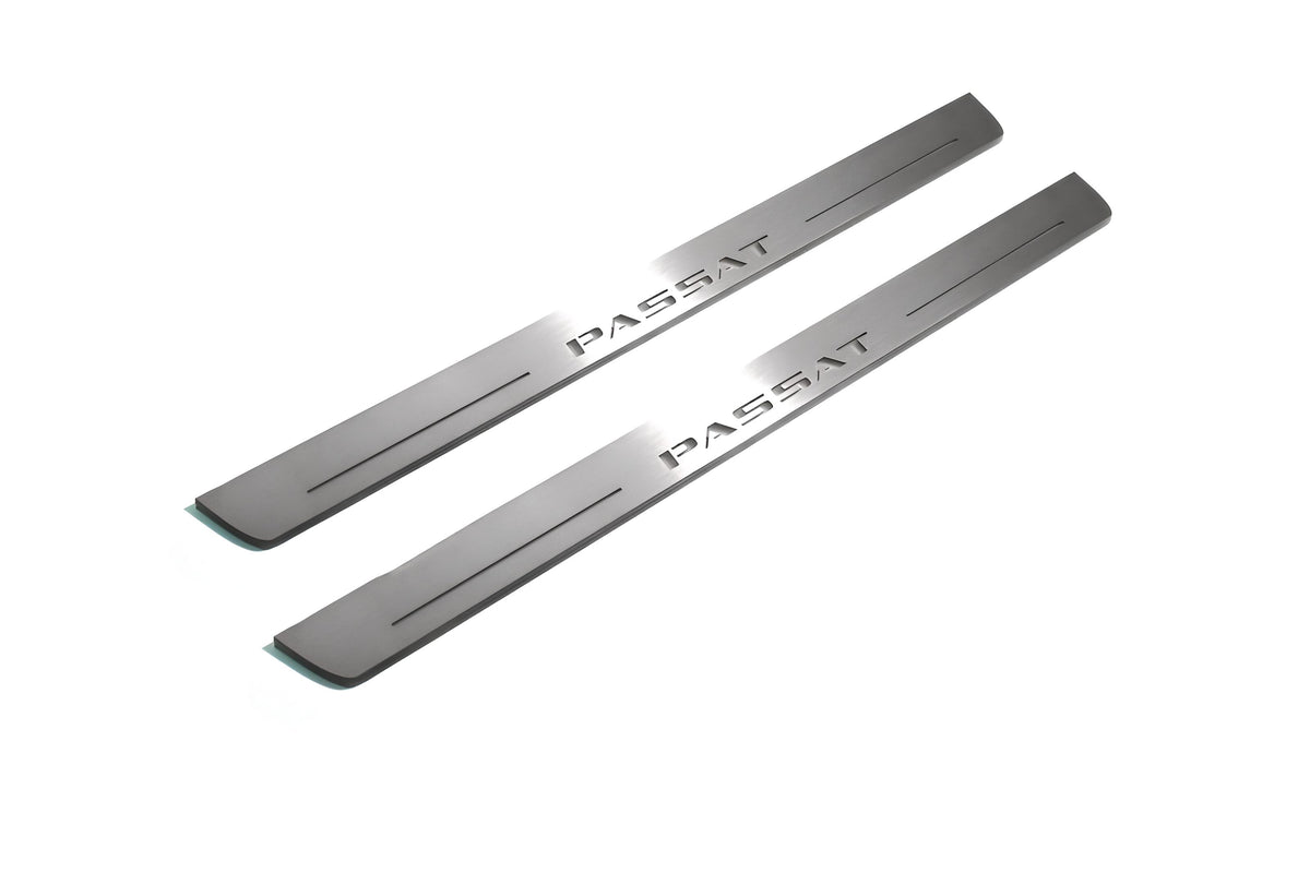 Two long silver-finished door sill plates with Passat lettering on a light background, angled view.