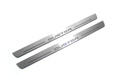 Two long silver-finished door sill plates with Duster lettering on a light background, angled view.