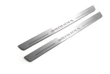 Two long silver-finished door sill plates with Sequoia lettering on a light background, angled view.