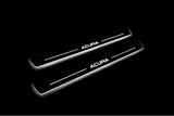 Two long door sill plates with Acura lettering and edges illuminated in white, angled view on a dark background.