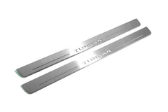 Two long silver-finished door sill plates with Tundra lettering on a light background, angled view.