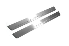 Two long silver-finished door sill plates with Charger lettering on a light background, angled view.
