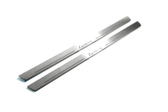 Two long silver-finished door sill plates with Lanos lettering on a light background, angled view.