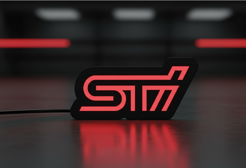 Subaru STI LED grille badge with red illumination at night