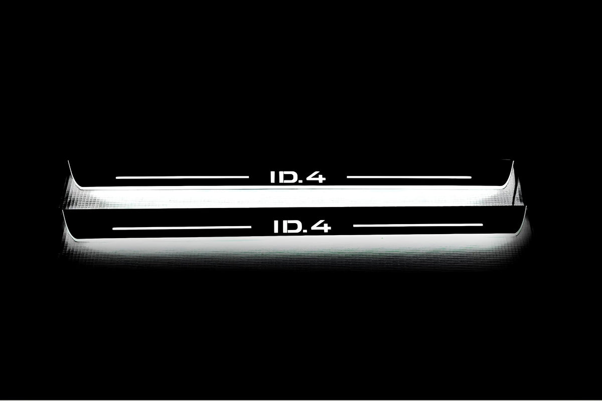 Two long door sill plates with ID.4 lettering and edges illuminated in white, straight-on view on a dark background.