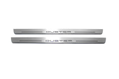 Two long silver-finished door sill plates with Duster lettering on a light background, straight-on view.