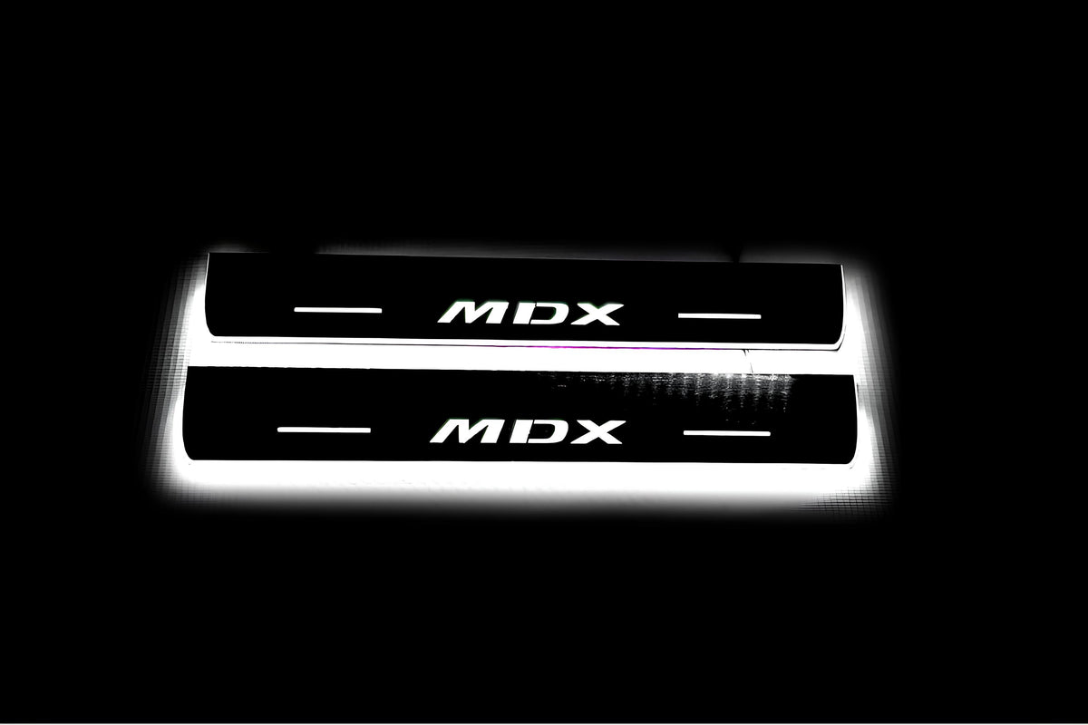 Two short door sill plates with MDX lettering and edges illuminated in white, straight-on view on a dark background.
