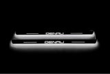 Two short door sill plates with Denali lettering and edges illuminated in white, straight-on view on a dark background.