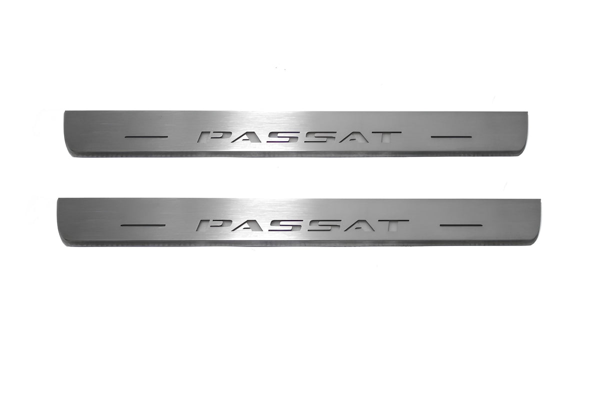 Two short silver-finished door sill plates with Passat lettering on a light background, straight-on view.