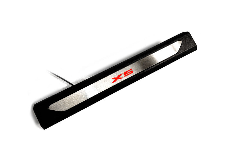Black molded threshold trim with a silver insert bearing red X5 lettering and an attached wire, angled view on a white background.