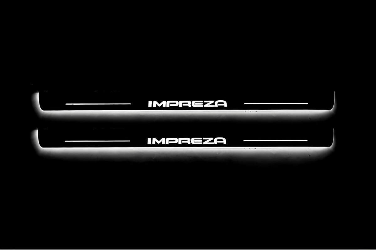 Two long door sill plates with Impreza lettering and edges illuminated in white, straight-on view on a dark background.