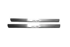 Two long silver-finished door sill plates with X6 lettering on a light background, straight-on view.