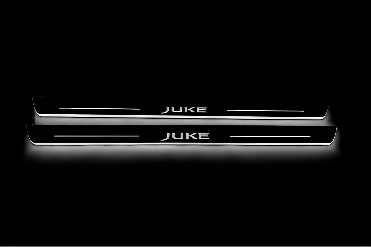 Two long door sill plates with Juke lettering and edges illuminated in white, straight-on view on a dark background.