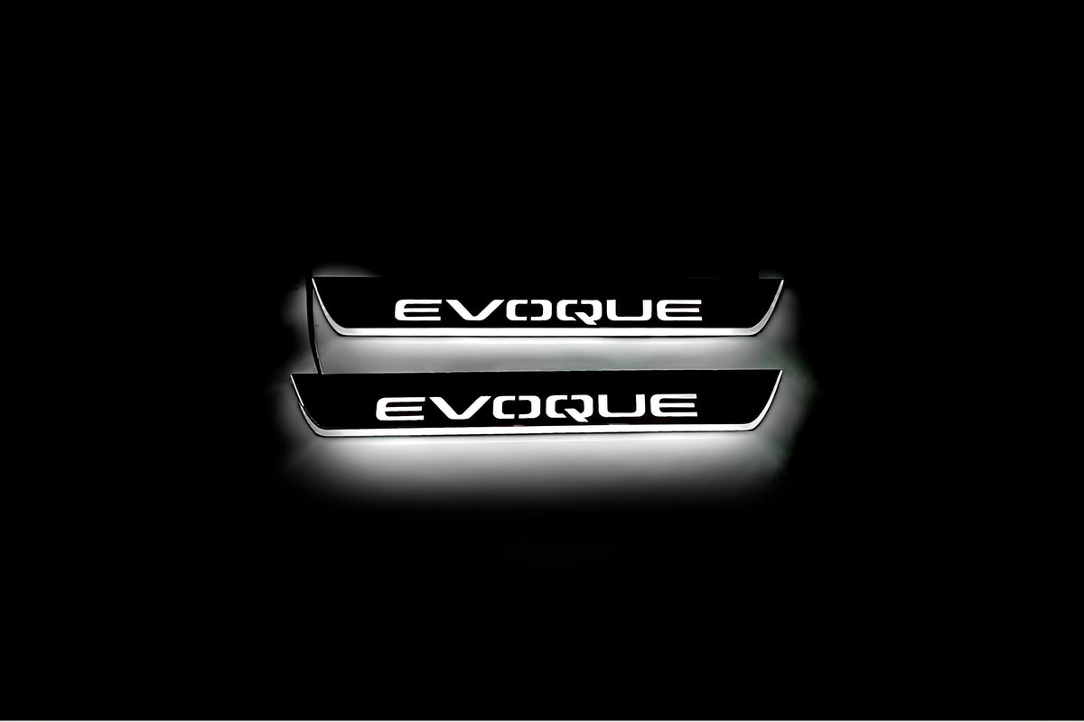 Two short door sill plates with Evoque lettering and edges illuminated in white, straight-on view on a dark background.
