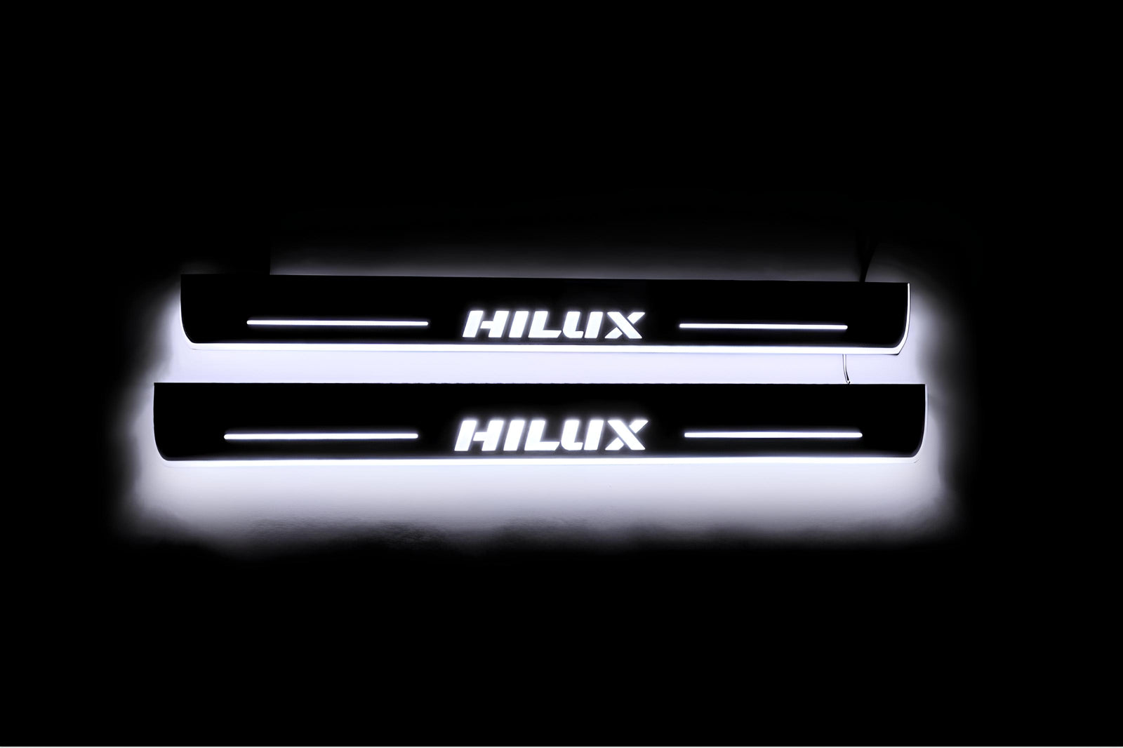 LED door sill plates Toyota Hilux VIII 2015+ in stainless steel with Hilux logo