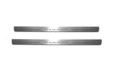 Two long silver-finished door sill plates with Passat lettering on a light background, straight-on view.