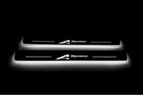 Two long door sill plates with A-Spec lettering and edges illuminated in white, straight-on view on a dark background.
