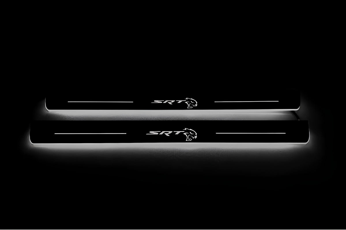 Two long door sill plates with SRT with a Hellcat head emblem lettering and edges illuminated in white, straight-on view on a dark background.