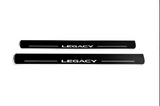 Two long black-finished door sill plates with white Legacy lettering and horizontal lines, straight-on view on a white background.