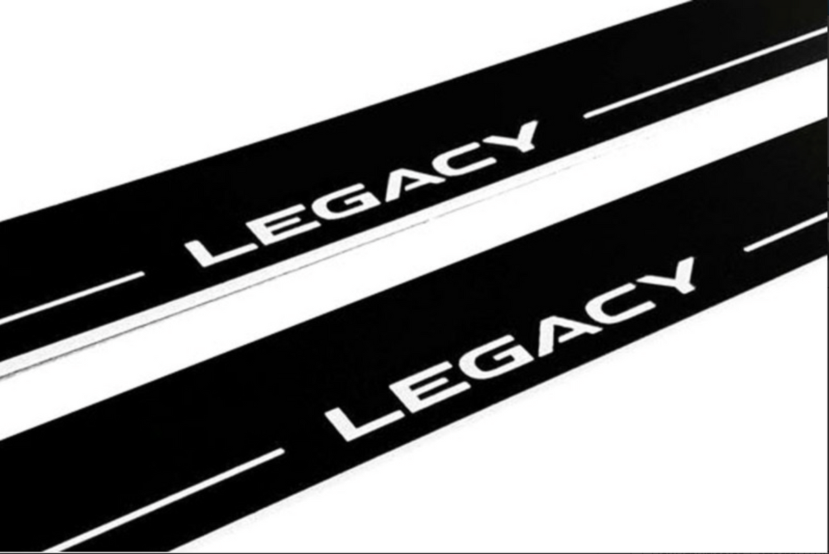 Close-up of Legacy lettering and horizontal lines on black-finished door sill plates.