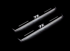 Two long door sill plates with 7X lettering and edges illuminated in white, angled view on a dark background.