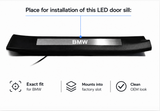 Installation diagram identifying the BMW insert position in a black molded threshold trim.