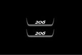 Two short door sill plates with 206 lettering and edges illuminated in white, straight-on view on a dark background.
