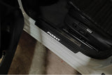 Volkswagen Passat B8 2015+ illuminated door sill protectors in matte black coated stainless steel with Passat logo