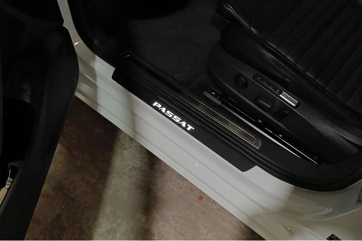 Volkswagen Passat B8 2015+ illuminated door sill protectors in matte black coated stainless steel with Passat logo