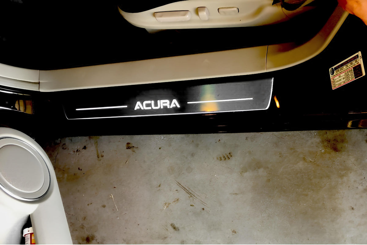 Reflective Acura door sill fitted beside beige interior trim and an open vehicle door; installation example.