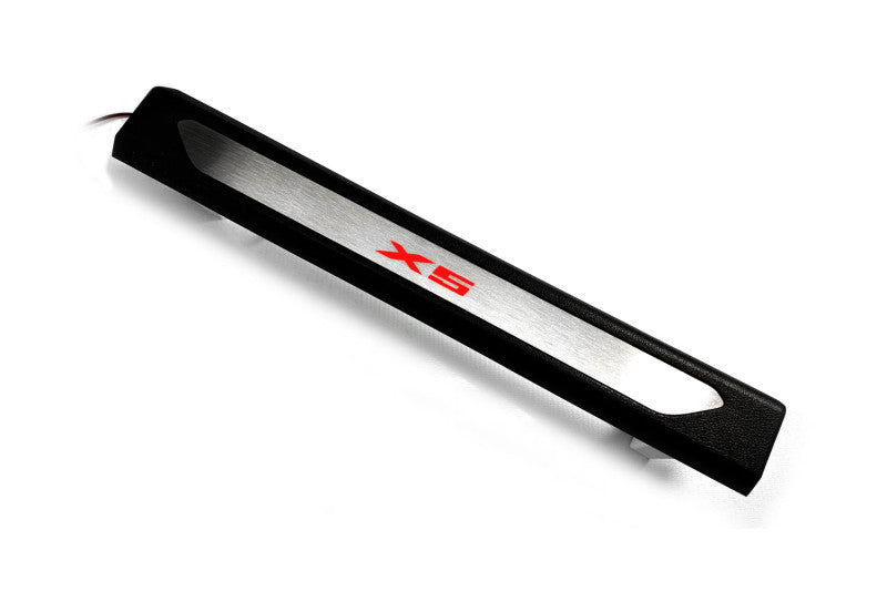 Black molded threshold trim with a silver insert bearing red X5 lettering and an attached wire, angled view on a white background.