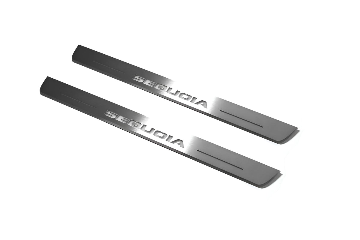 Two short silver-finished door sill plates with Sequoia lettering on a light background, angled view.