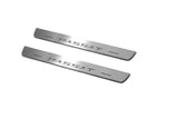 Two short silver-finished door sill plates with Passat lettering on a light background, angled view.
