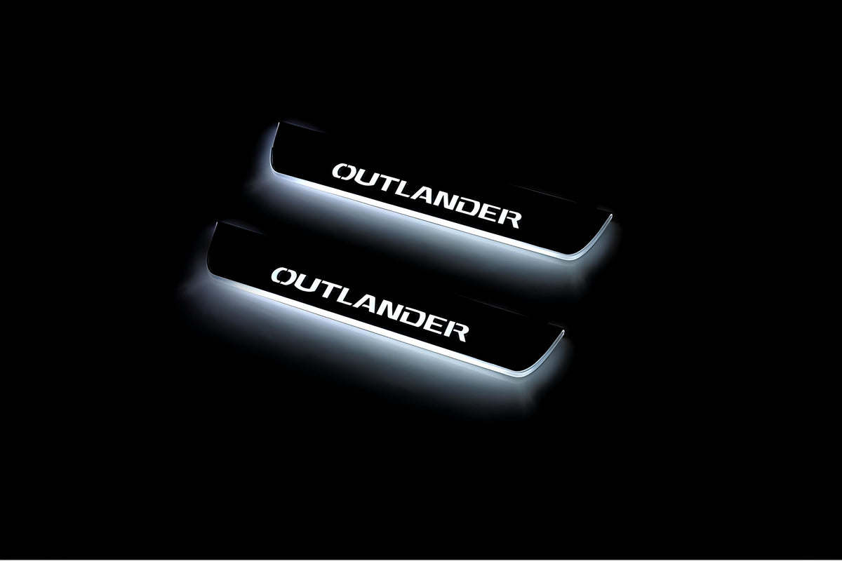 Two short door sill plates with Outlander lettering and edges illuminated in white, angled view on a dark background.