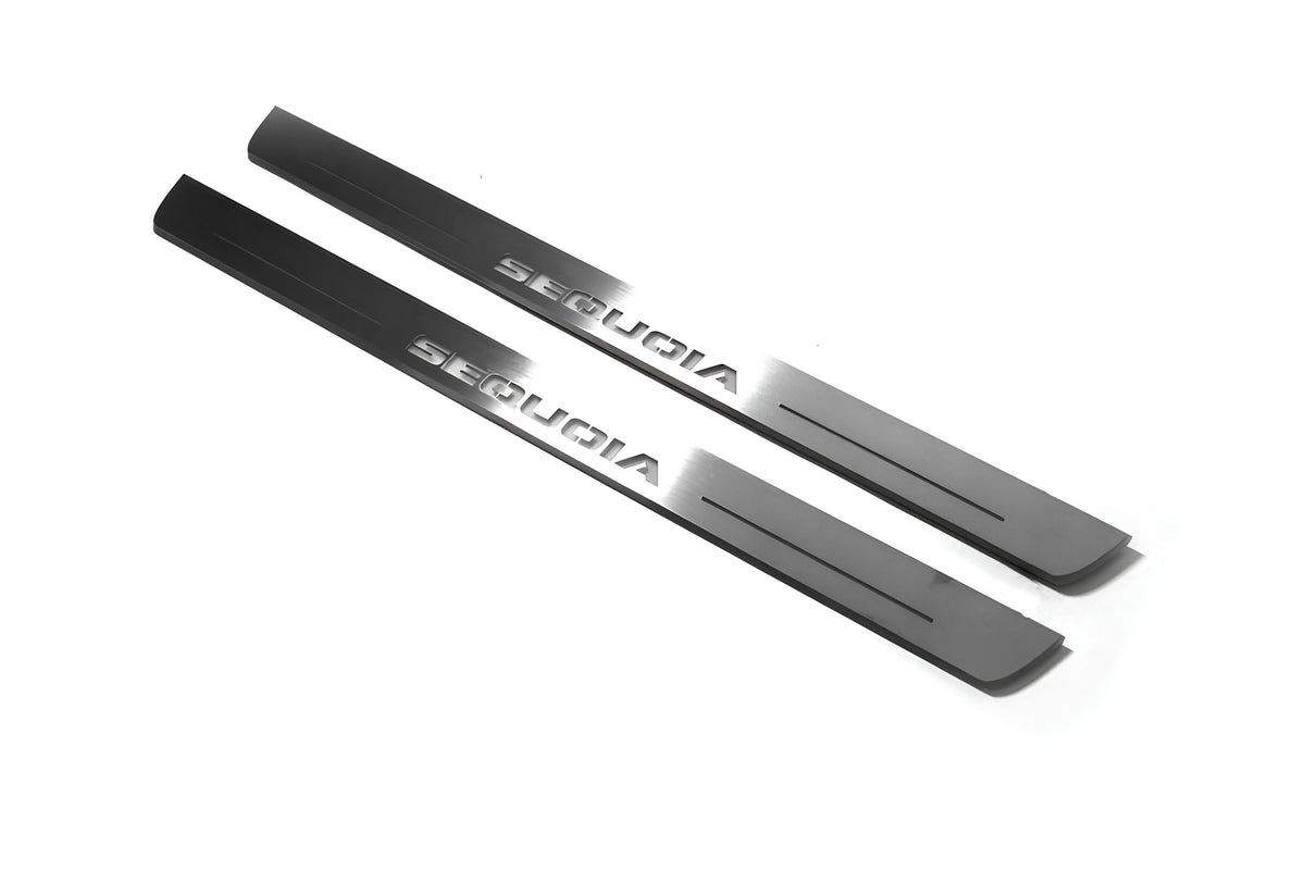 Two short silver-finished door sill plates with Sequoia lettering on a light background, angled view.