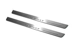 Two long silver-finished door sill plates with Passat lettering on a light background, angled view.