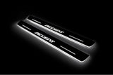 Two long door sill plates with Accent lettering and edges illuminated in white, angled view on a dark background.